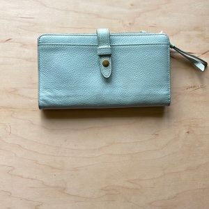 Fossil light blue wallet. Snap shut, with zipper on one side.